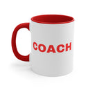White mug with red handle and interior, featuring the word 'COACH' in red.